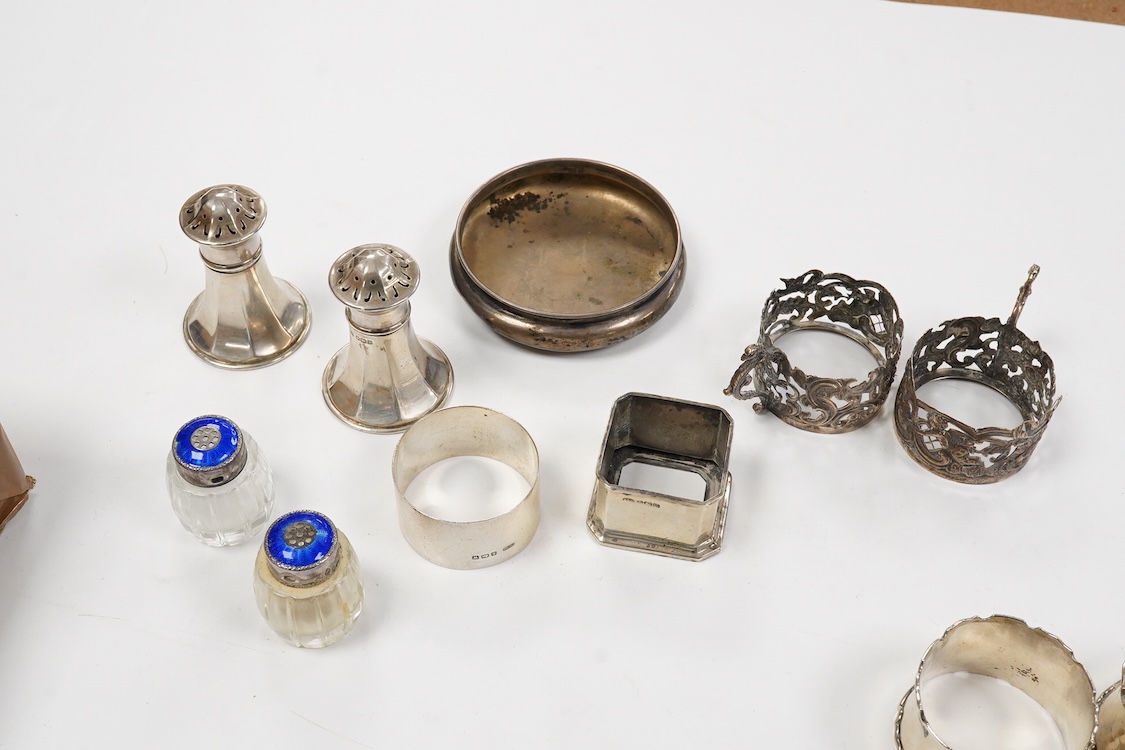 A collection of assorted silver to include five napkin rings including two pairs, a cased pair of glass butter dishes with silver butter knives, five golf related teaspoons, a cased set of six sterling cocktail sticks wi